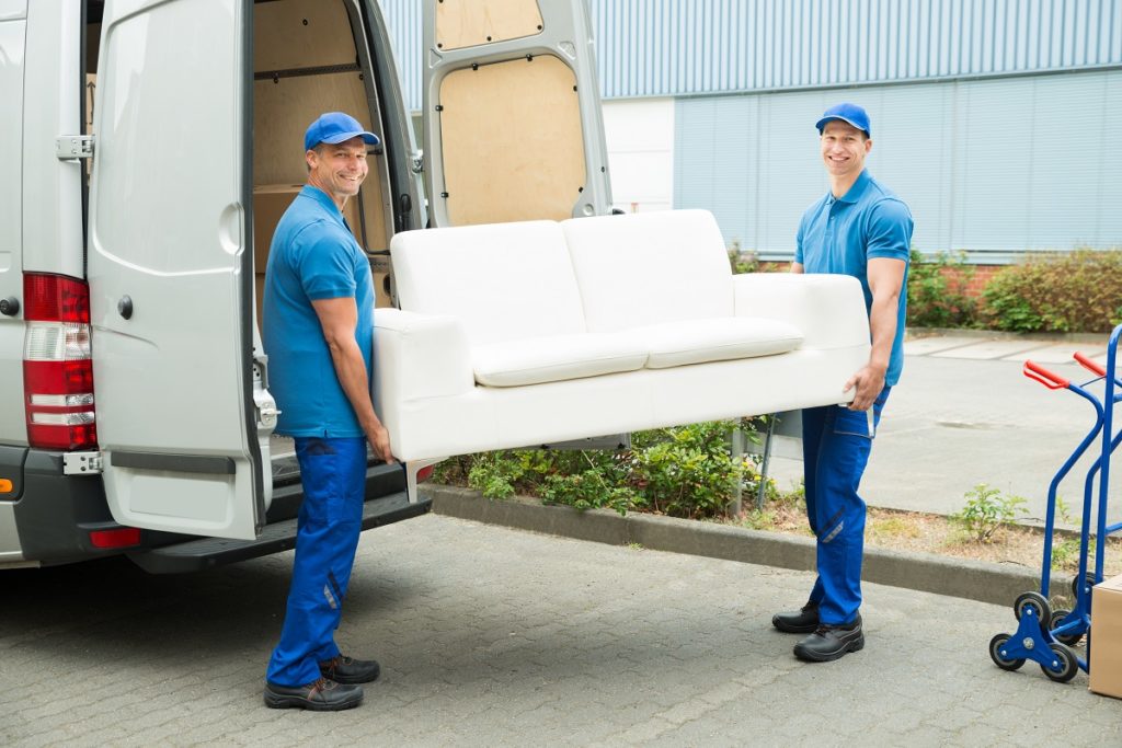 Movers putting the couch in the sprinter van