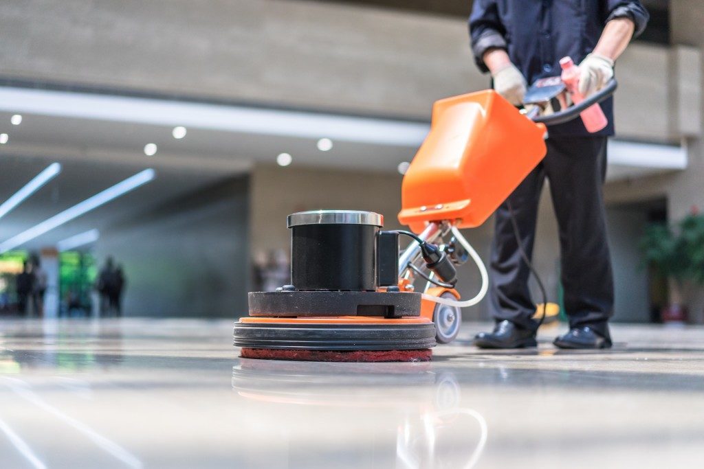 Professional cleaner polishing floor