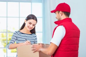 woman receiving and signing a package