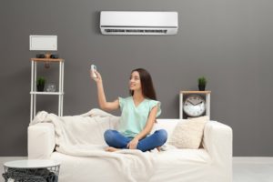 woman controlling AC unit