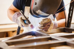 man welding a metal frame