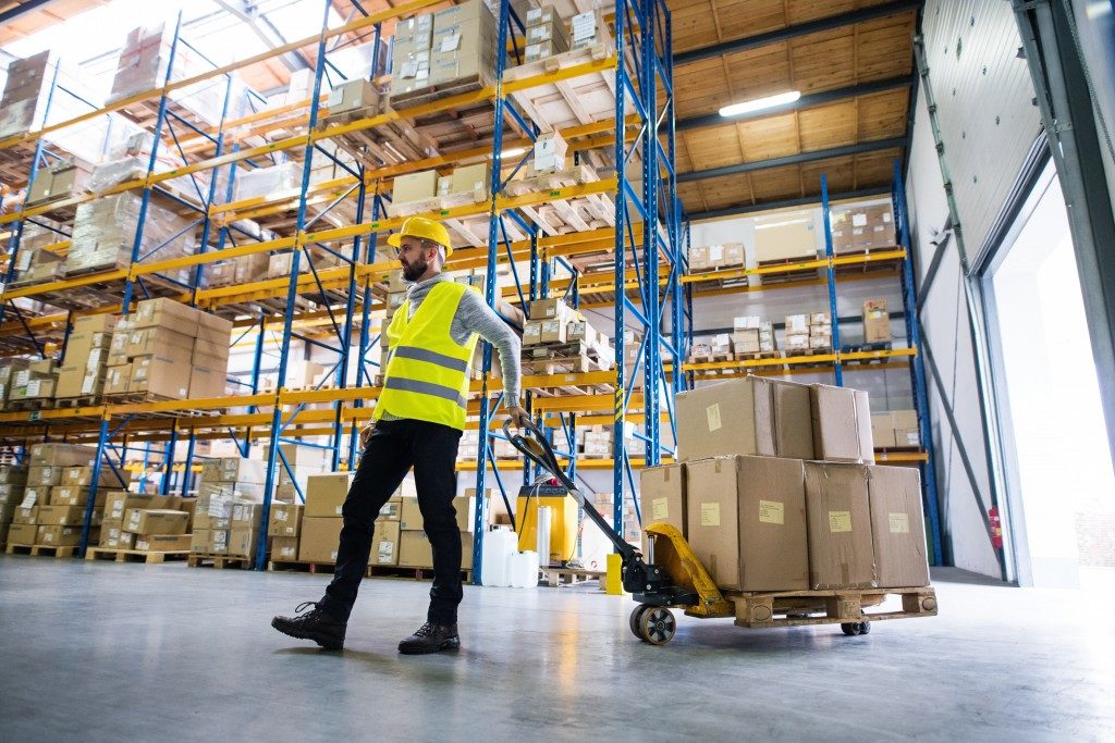 Warehouse worker pulling a pallet truck