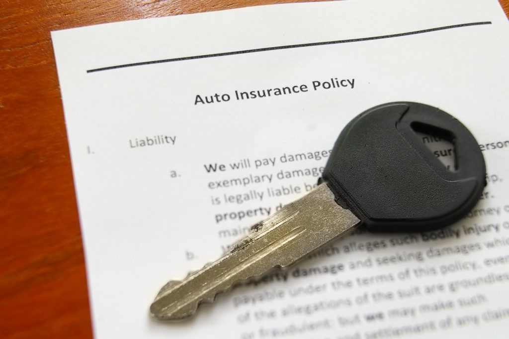 car keys and auto insurance policy