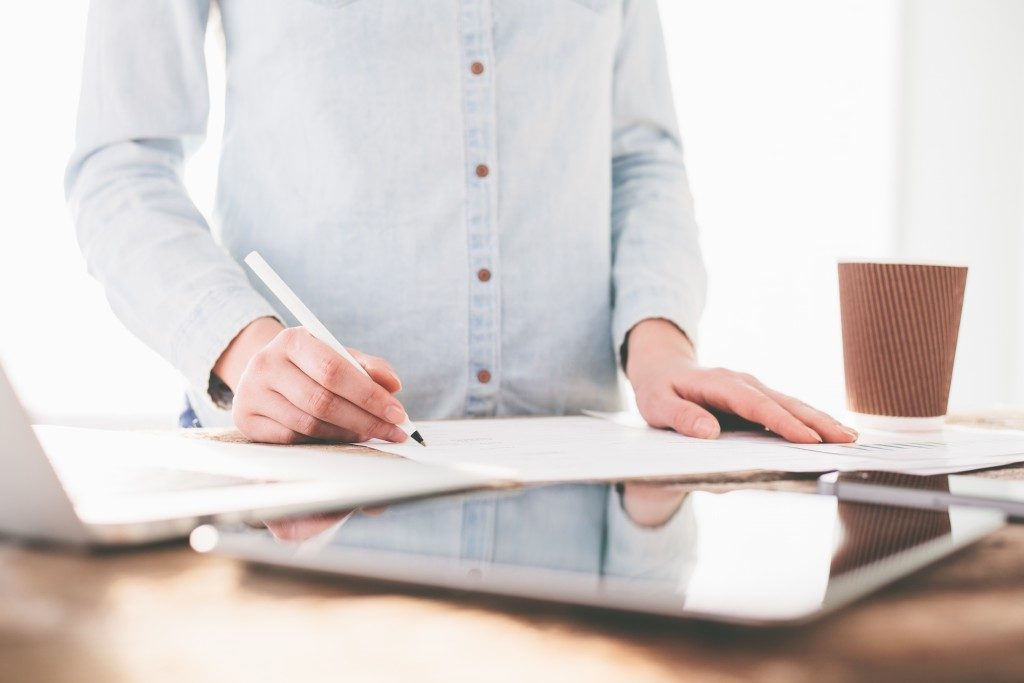 Someone working on the desk while standing