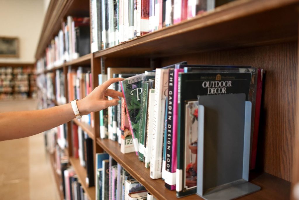 picking out a book from the shelf